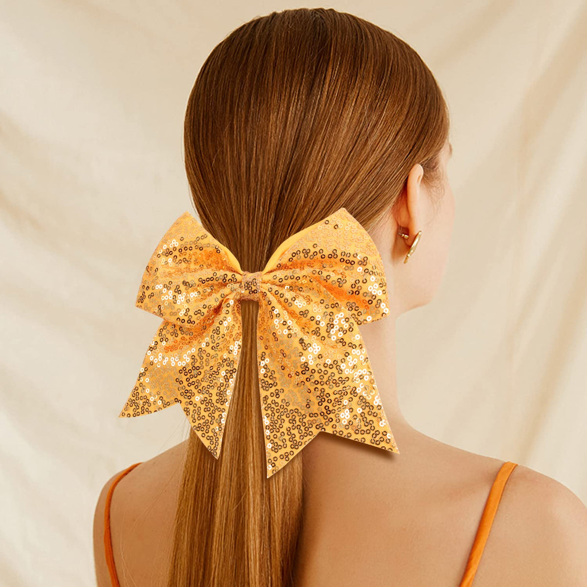 OAOLEER glitter bow on a ponytail supporting secure wear during jumps.