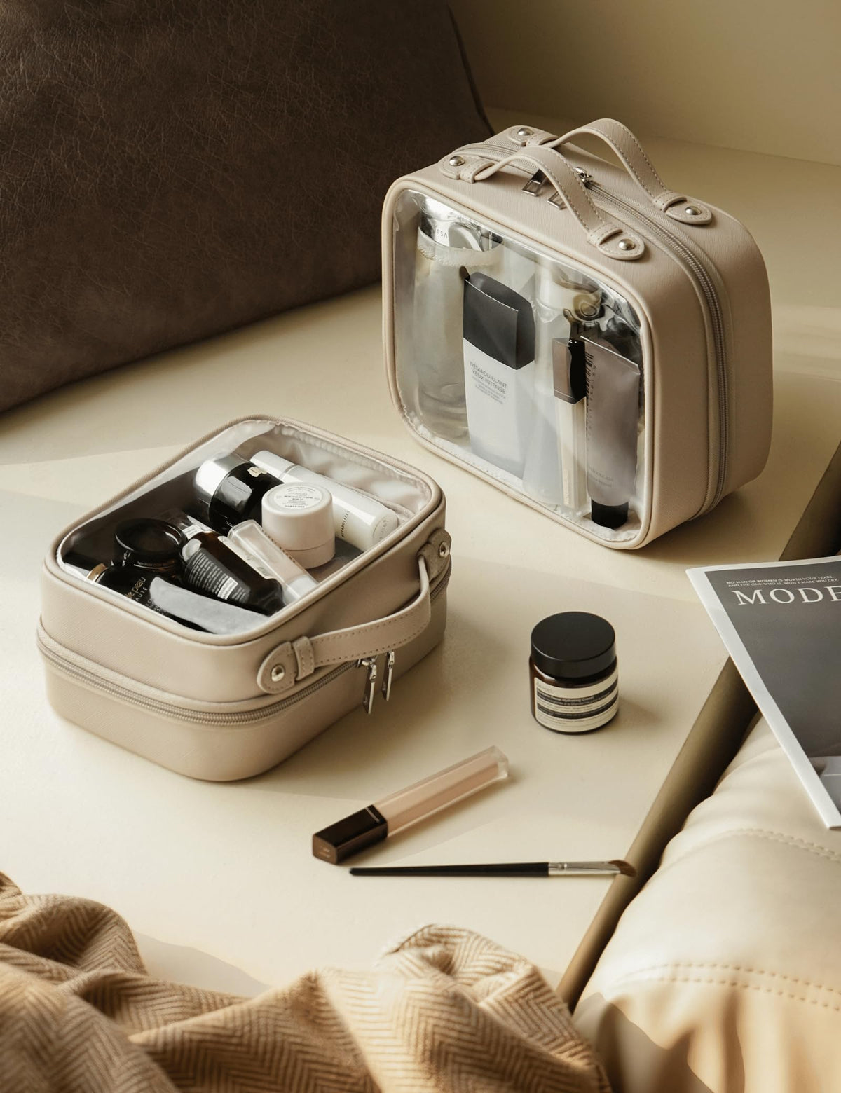 Oaque clear cosmetic bag on a suitcase demonstrates travel-friendly organization.