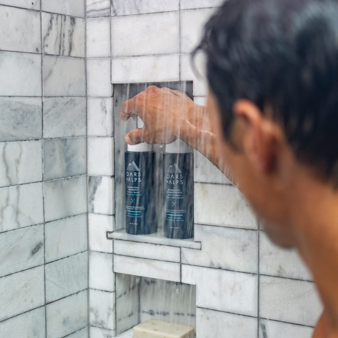 Oars + Alps Hydrating Conditioner application on hands, ready to apply to hair.