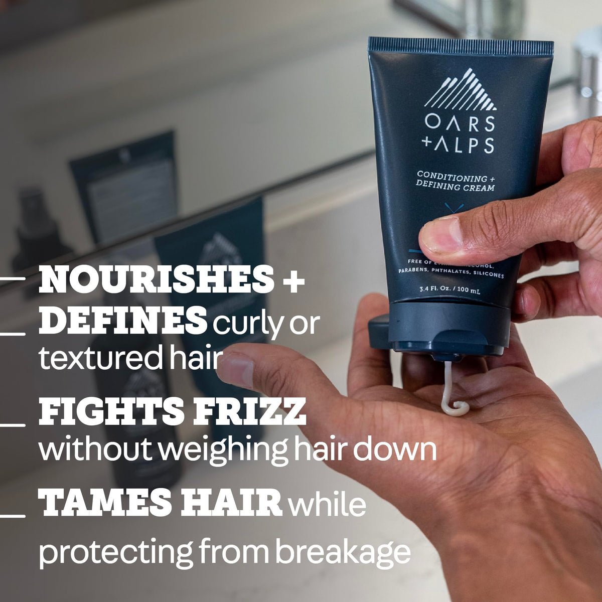 Oars + Alps Styling Cream in hand applying for lightweight hold and shine.