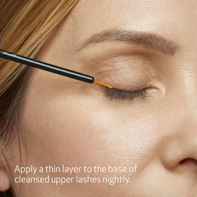 Obagi Nu-Cil nozzle dispensing a small amount of serum.