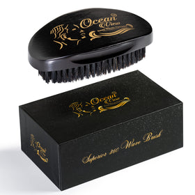 Ocean View Deep Waves Pomade wooden palm brush close-up highlighting ergonomic design for wave styling.