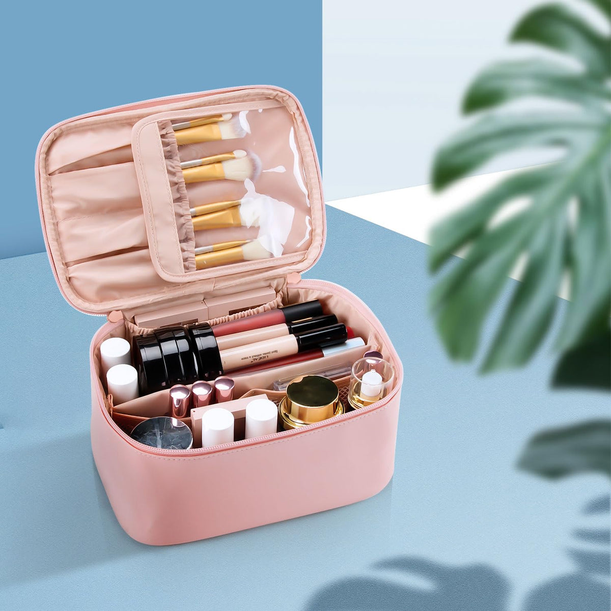 OCHEAL pink makeup bag pictured in a suitcase during travel.