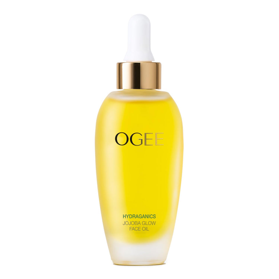 Ogee Jojoba Glow Face Oil bottle on a vanity, showcasing organic hydration for daily radiance.