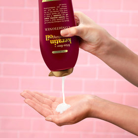 OGX bottle close-up highlighting shiny, smooth hair after use