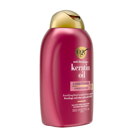 OGX Keratin Oil Conditioner texture close-up showing silky lather