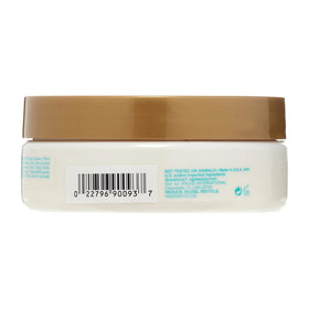 OGX Quenching Coconut Curls Butter bottle pour closeup for smooth curls