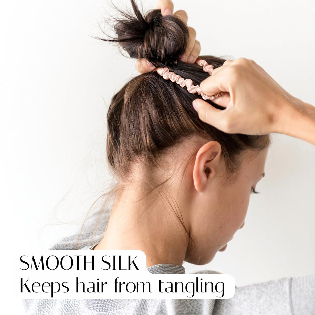 OLESILK skinny silk scrunchie wrapped around a ponytail for secure hold.