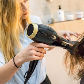 Olivia Garden 1875W hair dryer black and gold colorway in hand.