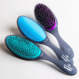 Travel-friendly Olivia Garden Aurora Detangler Brush for on-the-go styling.