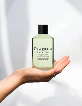 OLVERUM bath oil applied to skin for a silky, calming feel.