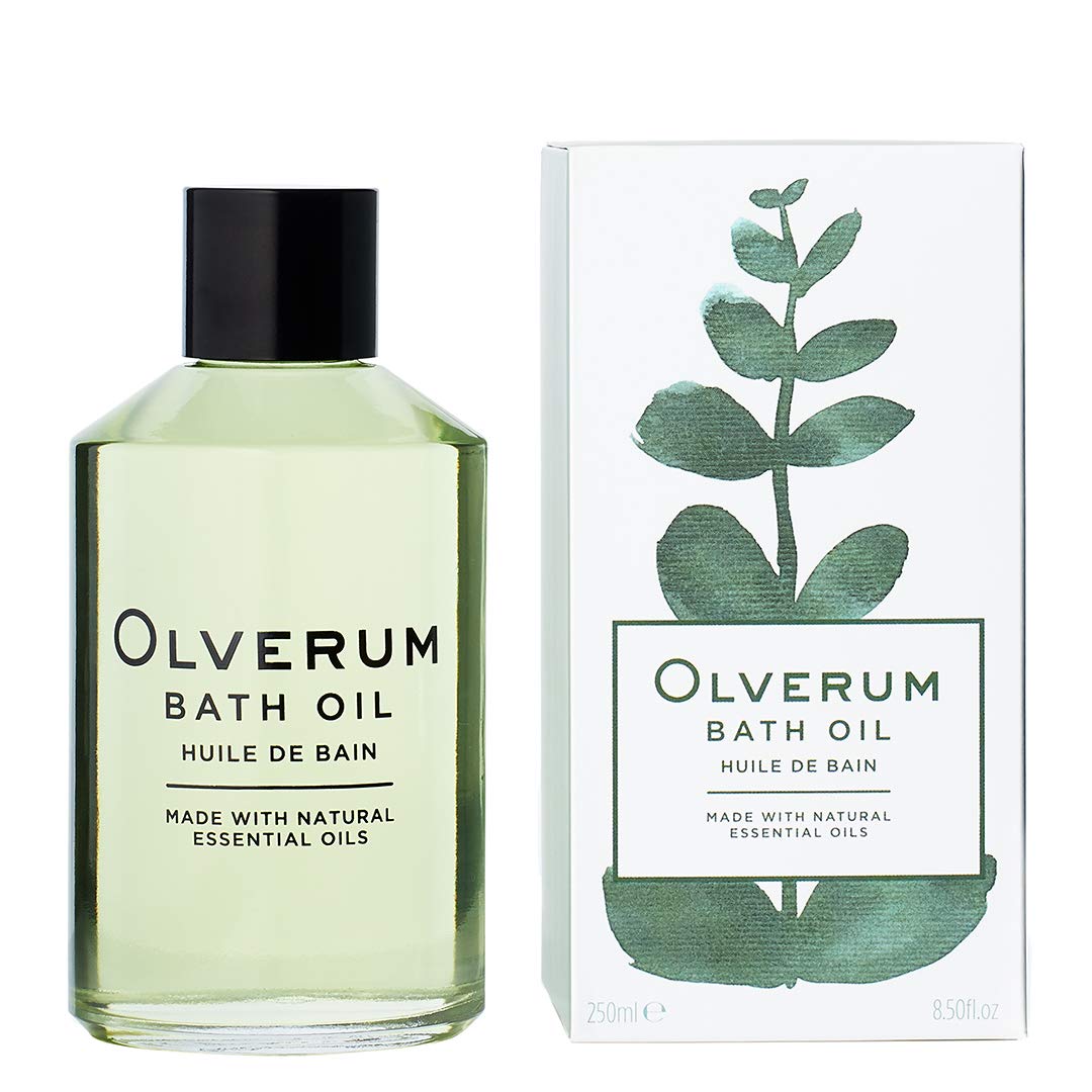 OLVERUM bath oil bottle on a clean spa setup for an at-home ritual.