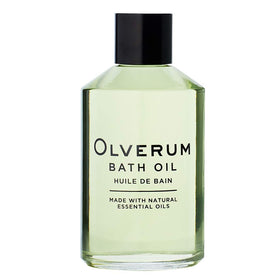 OLVERUM bath oil being poured into warm bath water for relaxation.