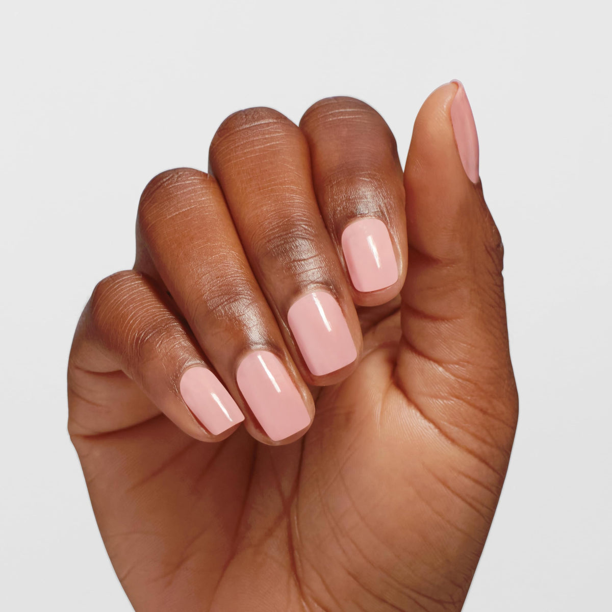 OPI Infinite Shine color Passion sheer pink swatch on nail for subtle elegance.