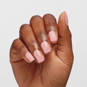OPI Infinite Shine color Passion sheer pink swatch on nail for subtle elegance.