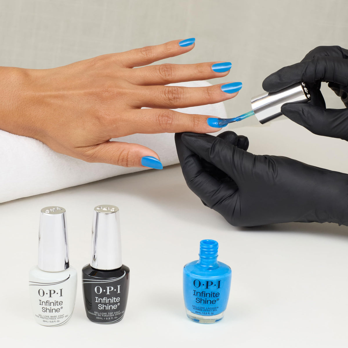 OPI Infinite Shine model hands wearing No Summer Blues manicure.