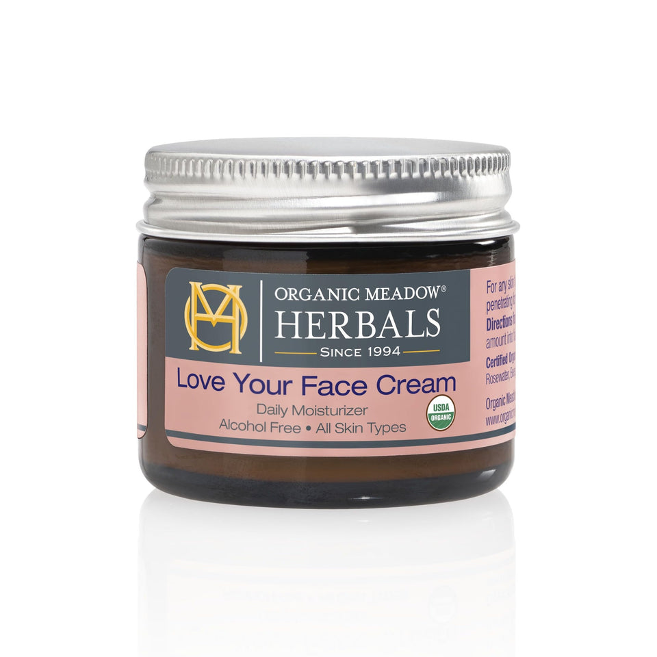 Organic Meadow Herbals Love Your Face Cream jar open for soothing daily skincare.