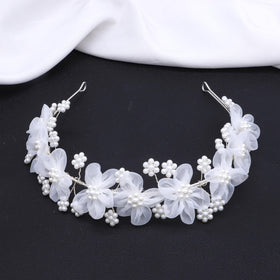 Oriamour flower girl headpiece with delicate tulle flowers, ideal for wedding snapshots.
