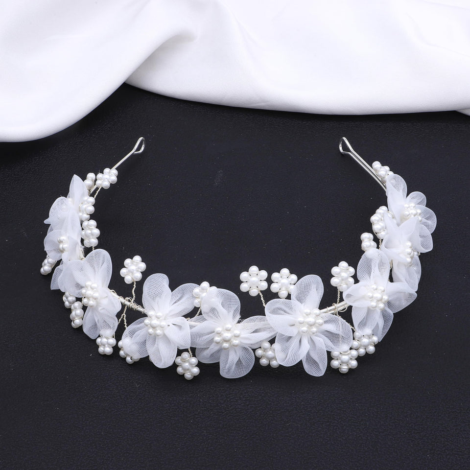 Oriamour flower girl headpiece with delicate tulle flowers, ideal for wedding snapshots.