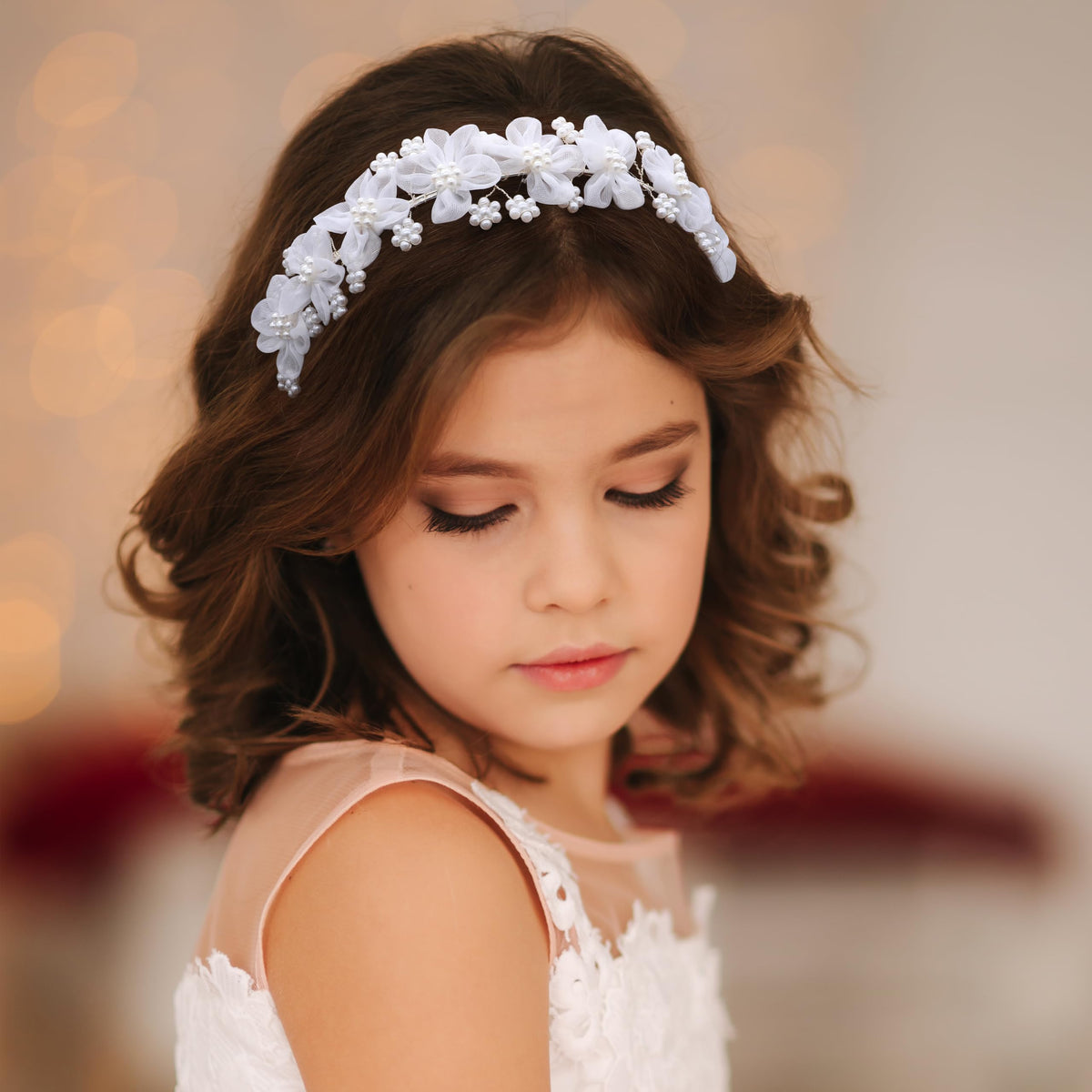 Oriamour pearl-embellished headband detail enhances a princess look for birthday parties.