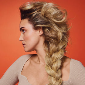 Hair styled with ORIBE serum for manageable softness and glow