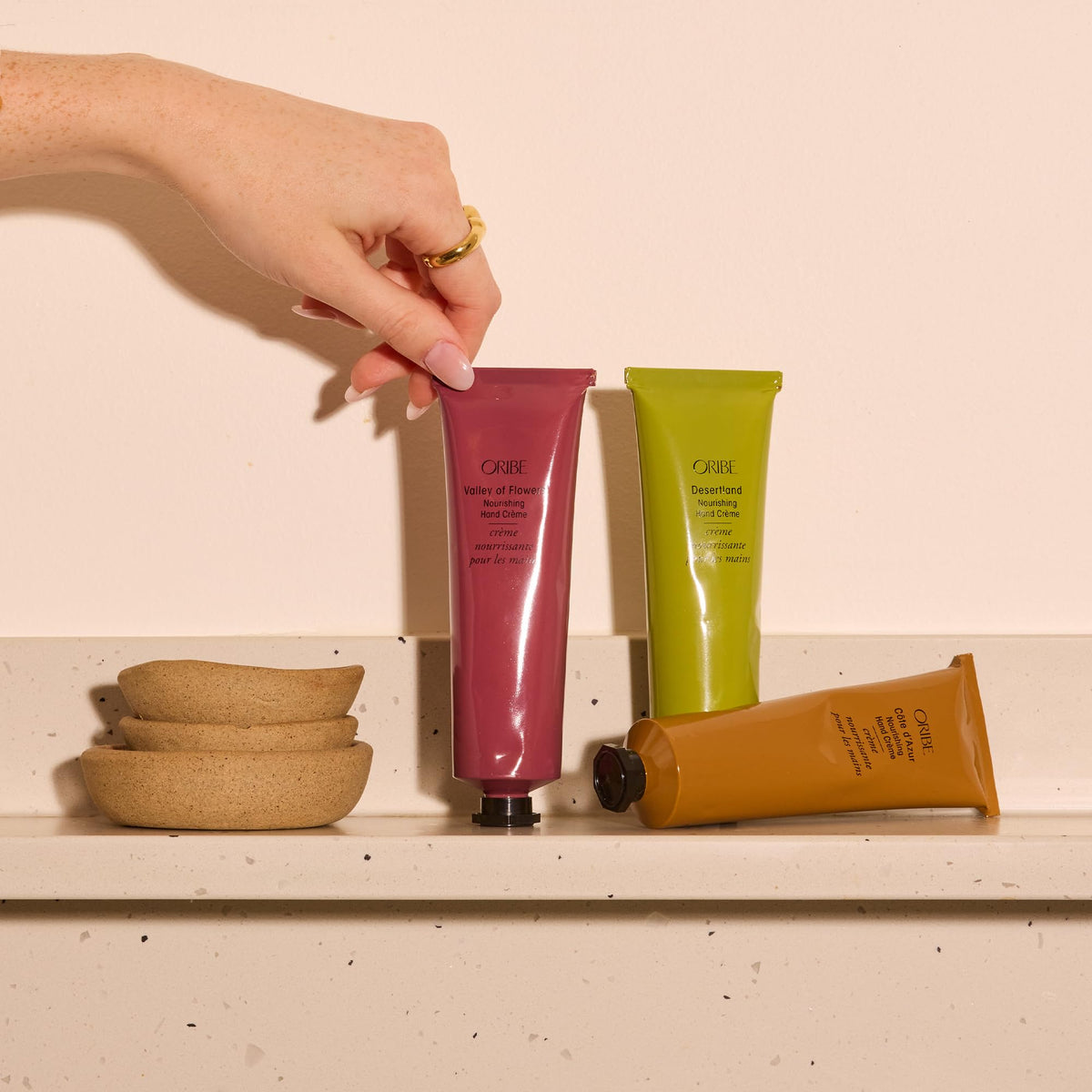 Oribe Côte d’Azur Nourishing Hand Crème tube packaging highlight easy portability.