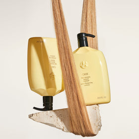 Oribe Hair Alchemy Resilience Shampoo rich lather demonstrates luxurious cleansing.