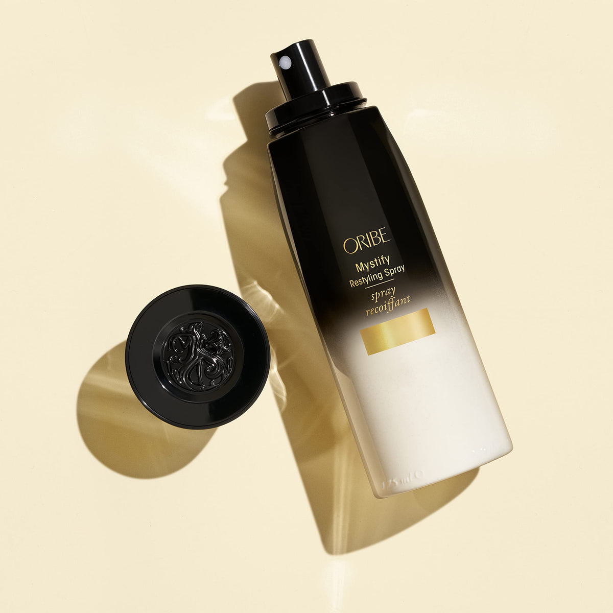 Oribe Mystify Restyling Spray close-up label highlights color-safe, vegan formula