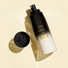 Oribe Mystify Restyling Spray close-up label highlights color-safe, vegan formula
