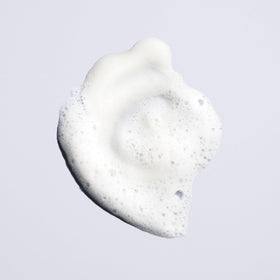 Oribe Run-Through Detangling Shampoo bottle with clear label and clean design