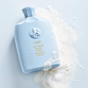 Oribe Run-Through Detangling Shampoo packaging in a stylish bottle