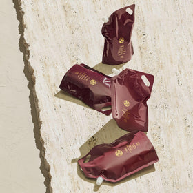 Oribe shine after wash image suggests glossy, healthy-looking strands.
