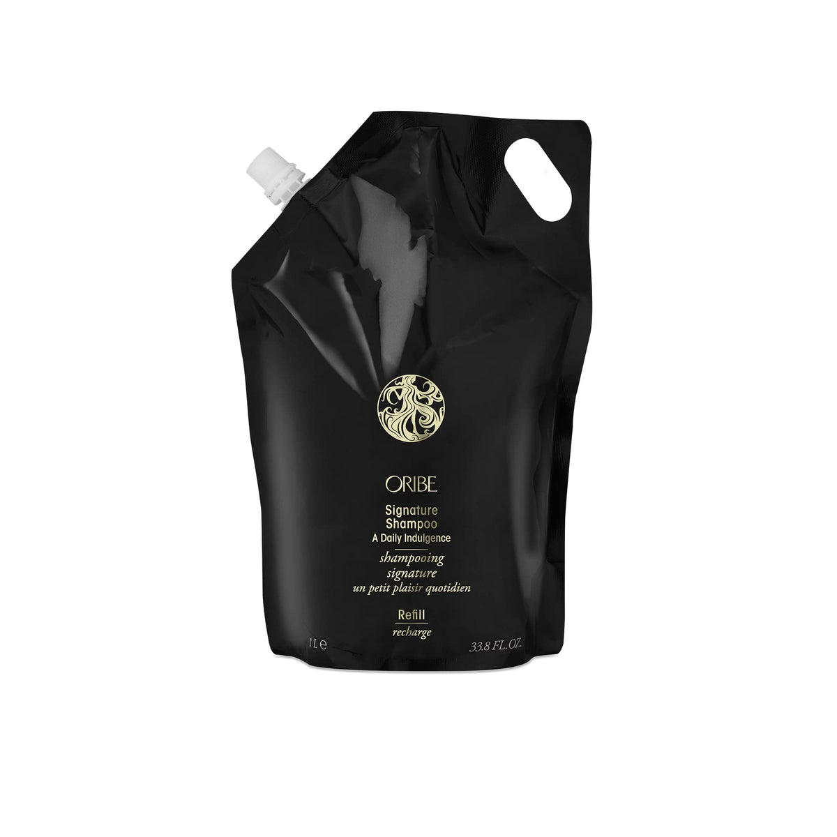 Oribe Signature Shampoo bottle on shelf for premium cleansing across hair types.