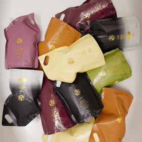 Oribe Signature Shampoo liter refill pouch reduces plastic while preserving formula quality.