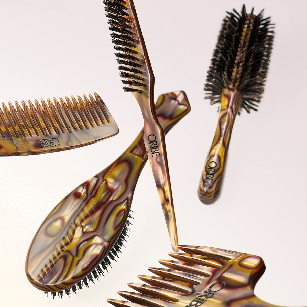 Oribe Wide Tooth Comb used on dry hair for smooth styling.