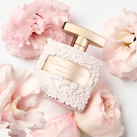 Close-up of Bella Rosa bottle with pink rose accents highlights floral notes.