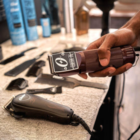Oster Classic 76 burgundy clipper with detachable blade for versatile wet or dry cutting.