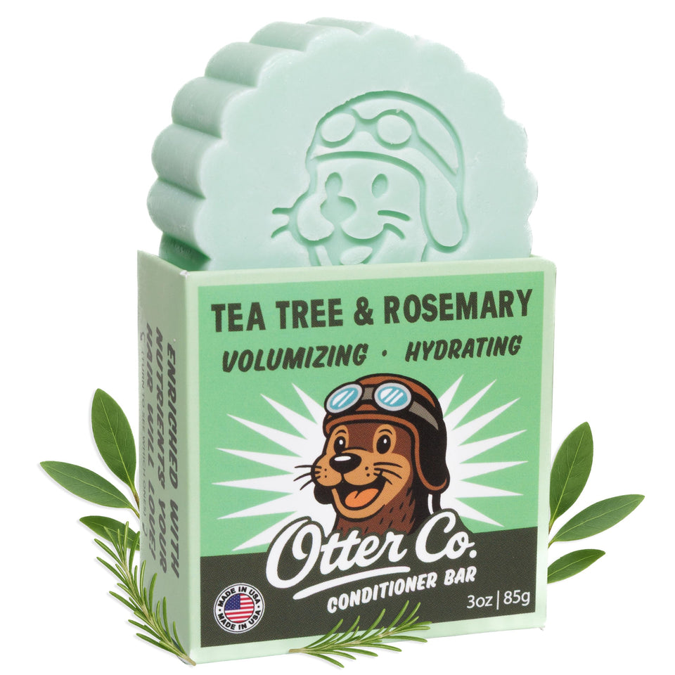 Packaging for Otter Co Tea Tree Rosemary Conditioner Bar highlights plastic-free, travel-friendly design.
