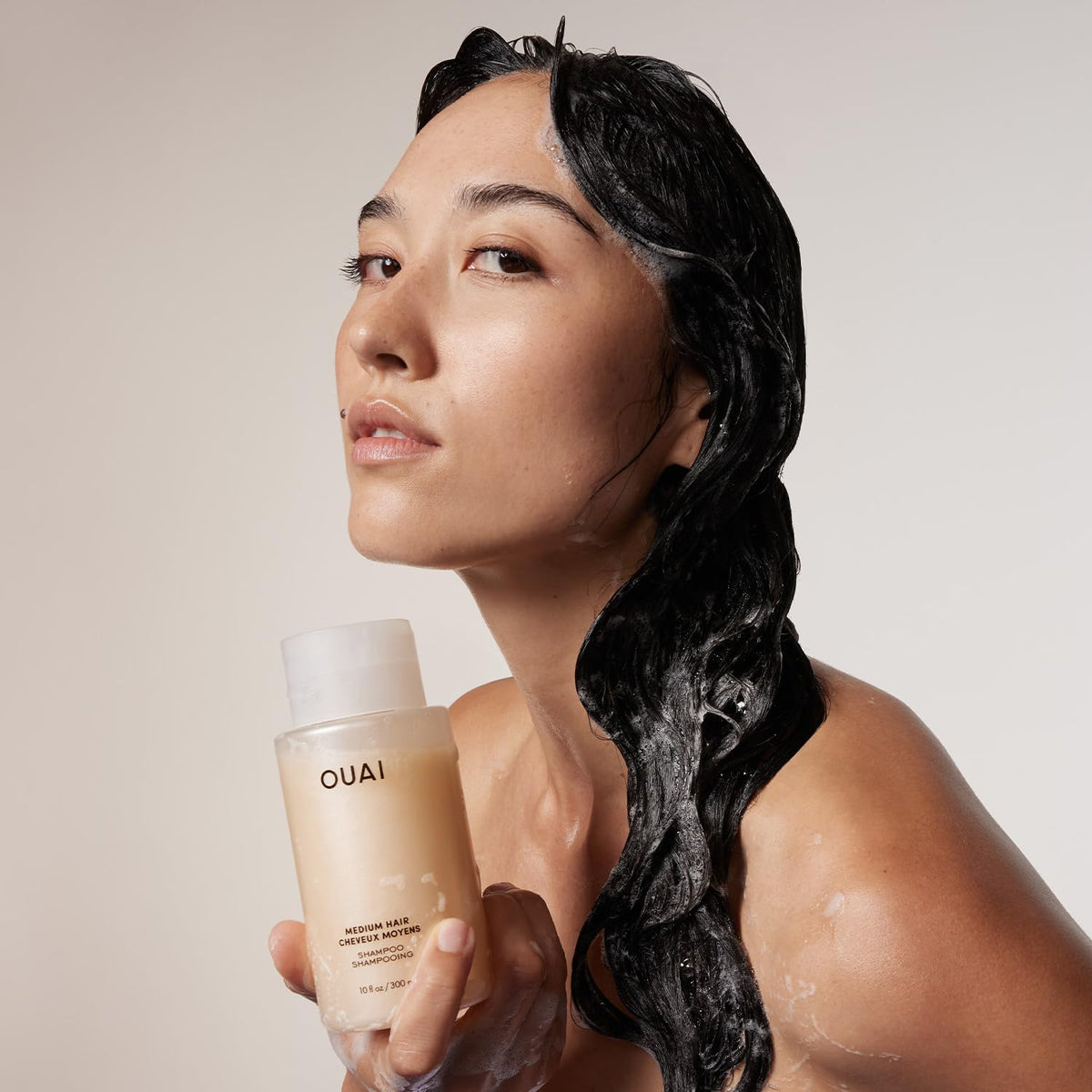 OUAI Medium Hair Shampoo with babassu oil nourishes scalp and strands.