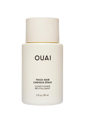 OUAI Thick Hair Conditioner travel size bottle pour for detangling and frizz control.