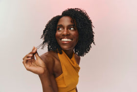 Damp curls styled with Ouidad Coil Infusion for frizz control and light hold