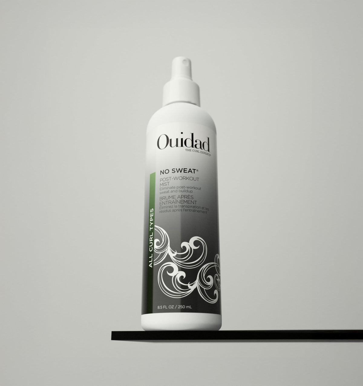 Ouidad No Sweat Post-Workout Mist closeup shows quick misting on curls.