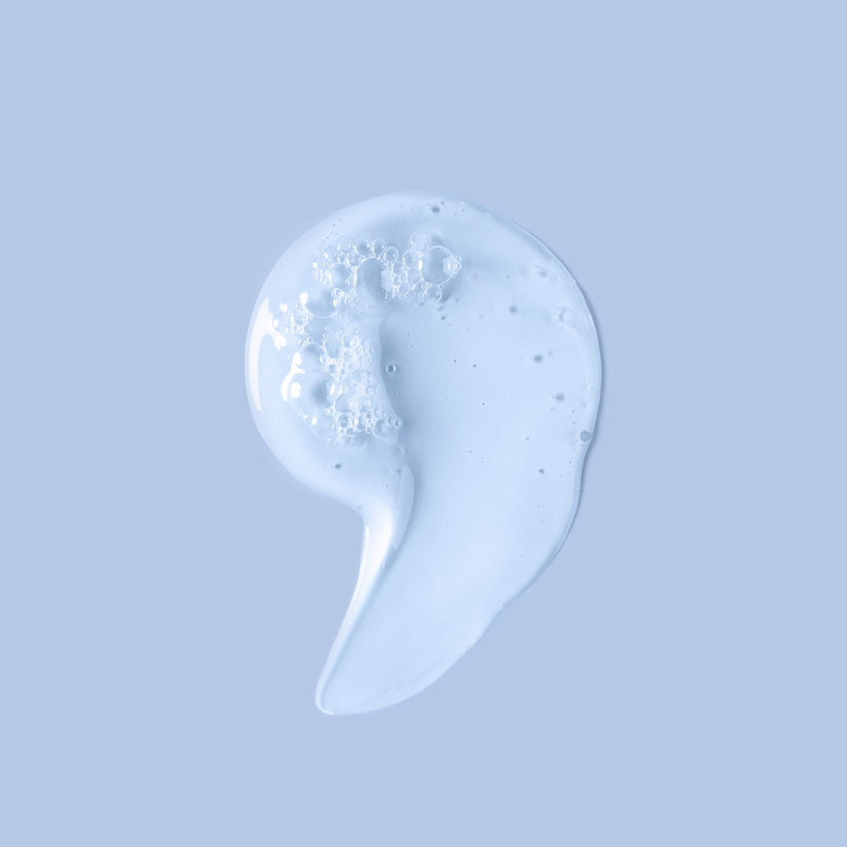 Ouidad Unbreakable Bonds Shampoo on bathroom shelf with droplets suggesting refreshing hydration.