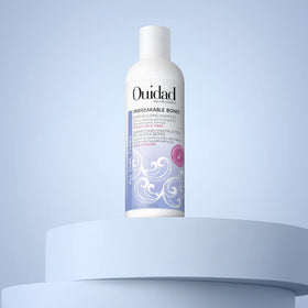 Ouidad Unbreakable Bonds Shampoo packaging hero shot emphasizing vegan collagen and moisture features.