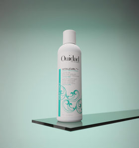 Ouidad VitalCurl Leave-In Serum on hair showing defined curls and shine