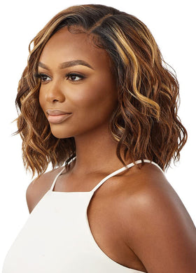 Nyla Sleeklay Part wig shade DRST2/Chocolate Caramel under warm lighting