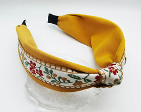 Outvie floral embroidered headband with a metal base for lasting wear.