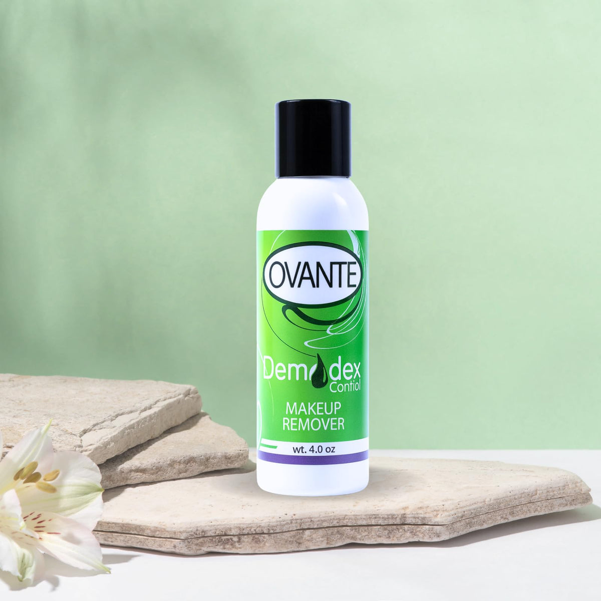 Ovante compact bottle on sink near cotton pads for daily routine.
