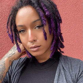 Hair after use showing vibrant purple tone and shine.