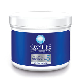 OxyLife Natural Radiance 5 Creme Bleach application close-up reveals smooth cream texture for gentle use.